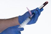 Attaching the second safety needle to the syringe